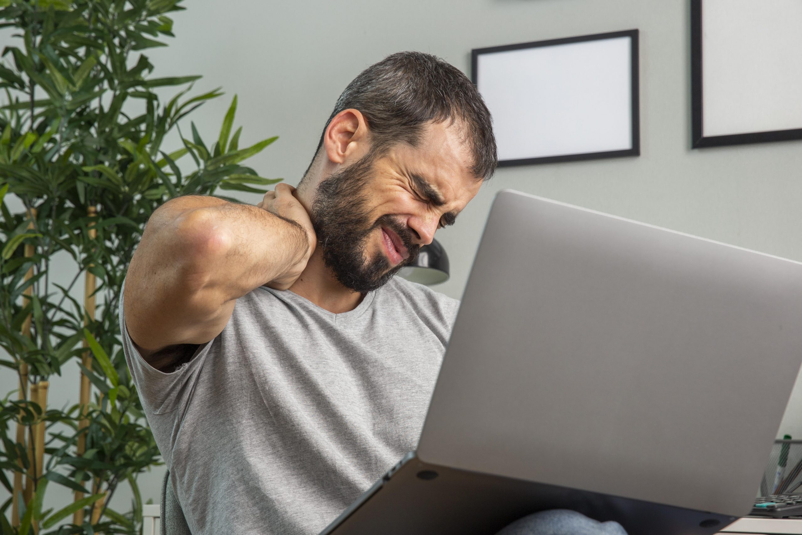 man-stretching-his-arms-while-working-from-home